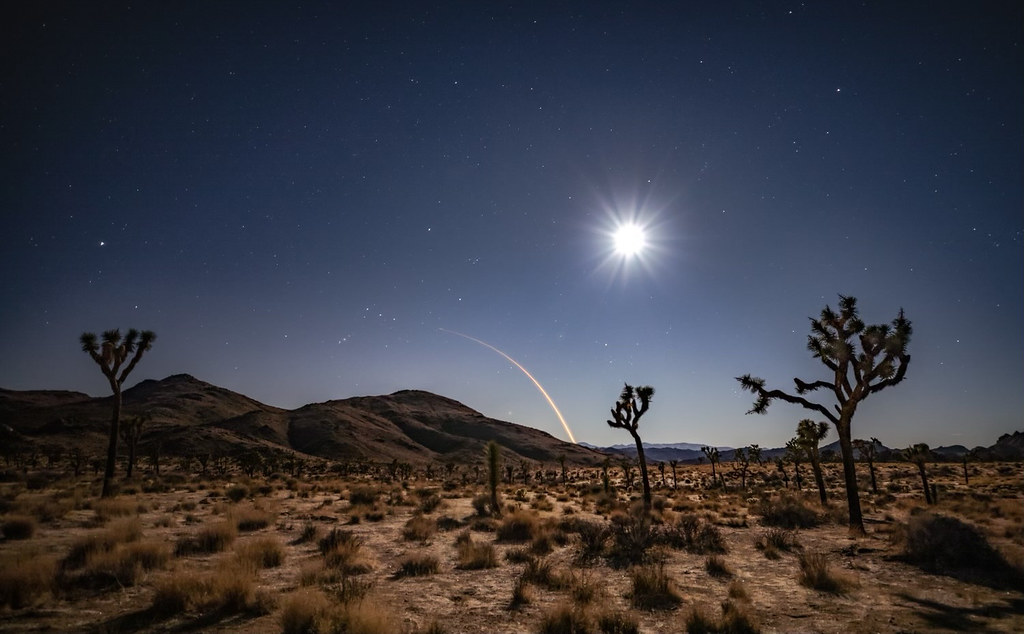 Starlink satellites providing coverage over remote desert landscape